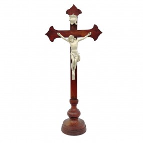Antique wooden standing crucifix with white-painted figure of Christ.