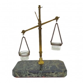 Antique brass precision balance with glass pans and marble base.