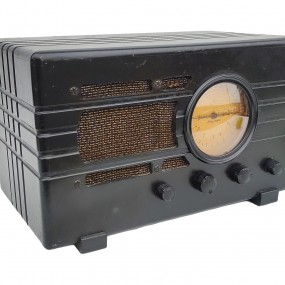 Vintage Silvertone tabletop radio featuring a black Art Deco-style case and circular dial.
