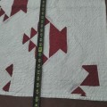 Handmade quilt with red geometric pattern. - 4