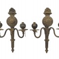 Pair of antique two-arm wall sconces featuring ornate classical detailing. - 1