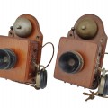 Pair of antique wooden wall telephones with bells and receivers. - 1