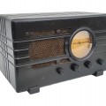 Vintage Silvertone tabletop radio featuring a black Art Deco-style case and circular dial. - 1